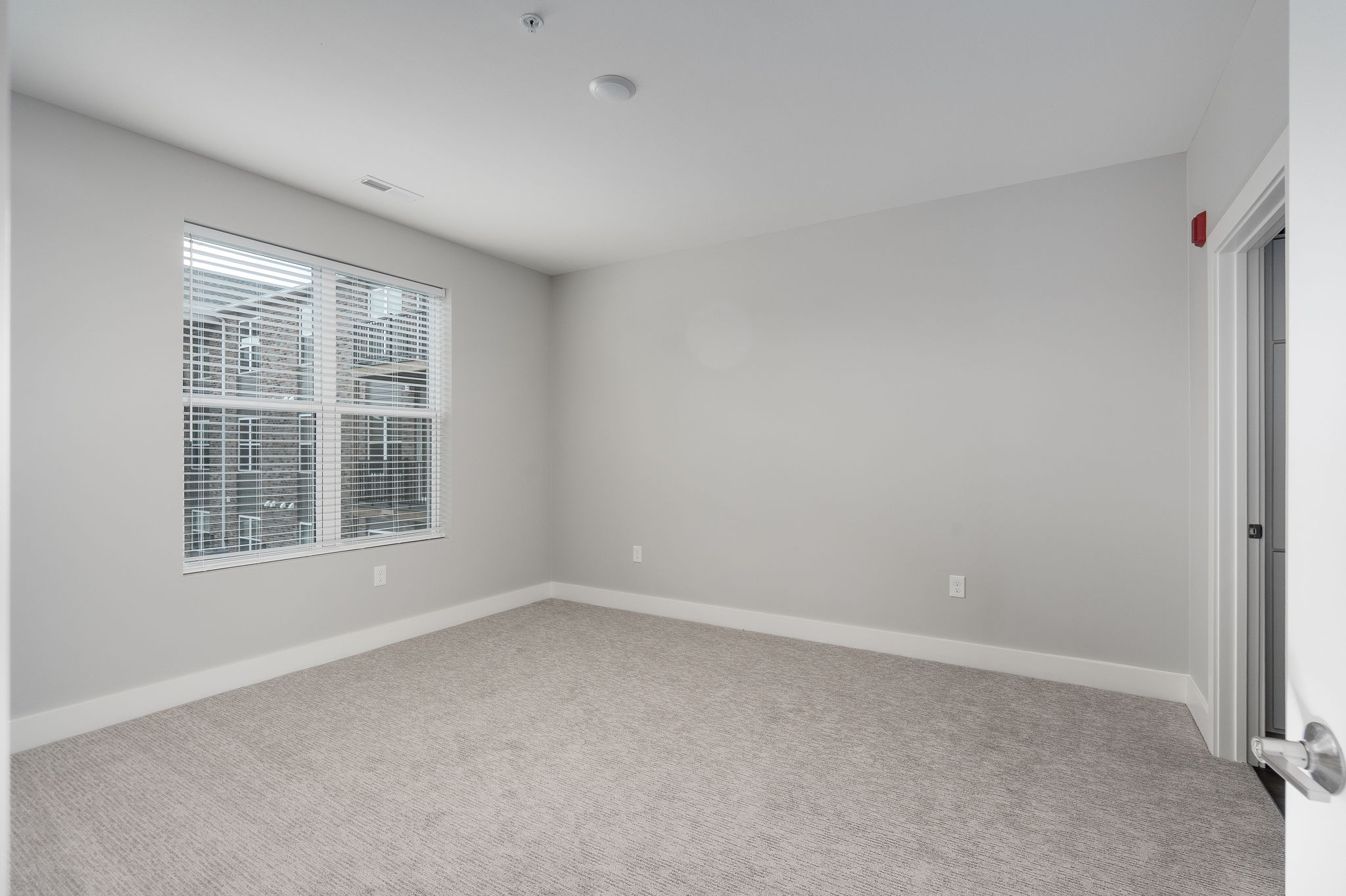 A room with a window and a door.